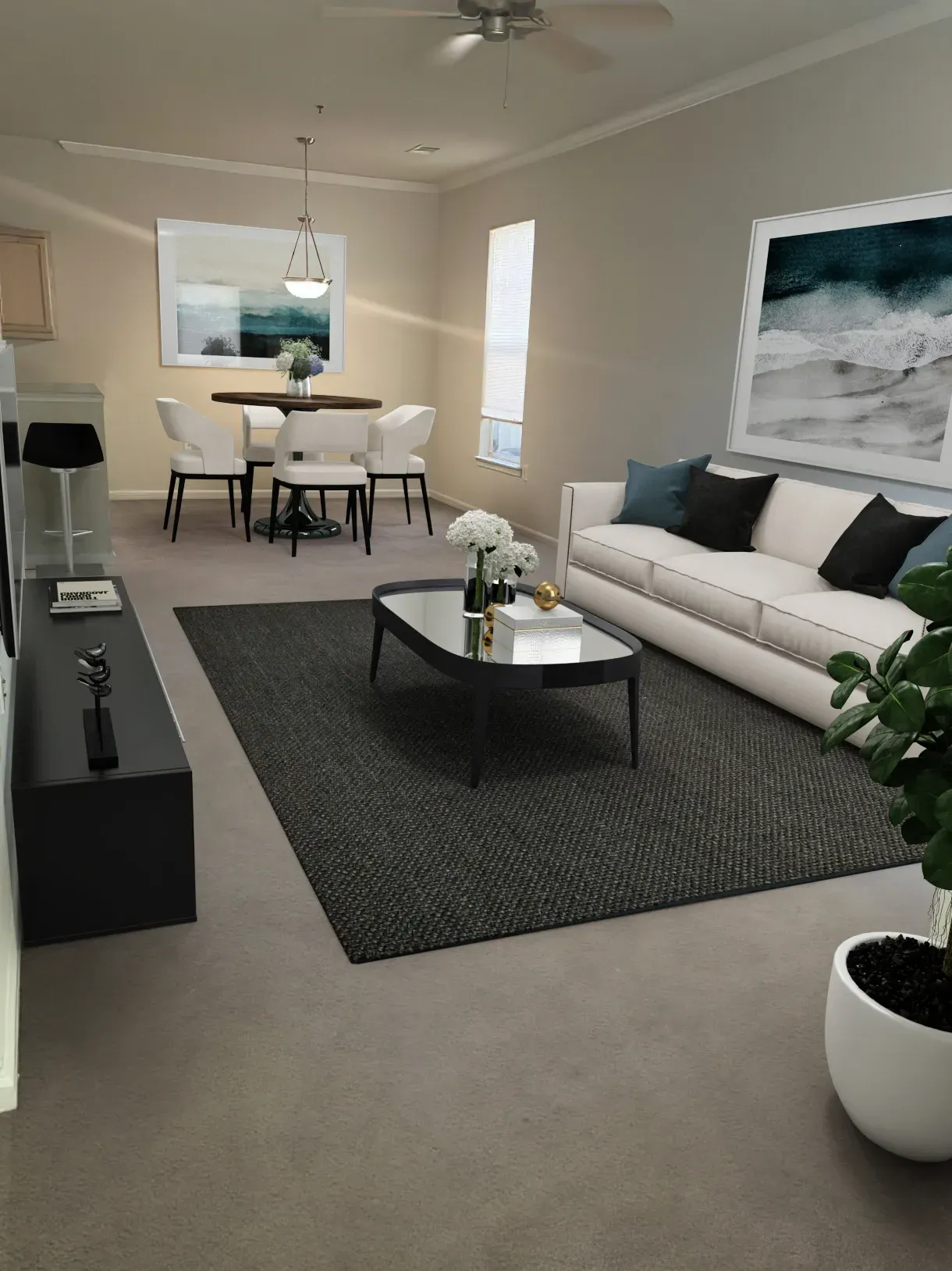 Open-concept living and dining area with a sofa, coffee table, dining set, and TV stand.