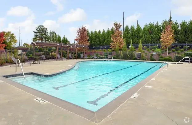 Outdoor swimming pool with lounge chairs and pergolas.