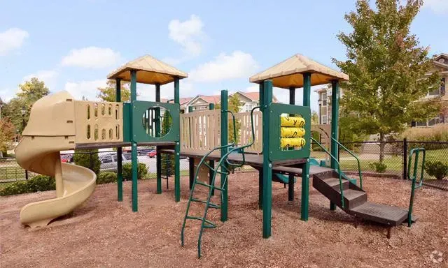 Playground with spiral slide, climbing ladder, and stairs.