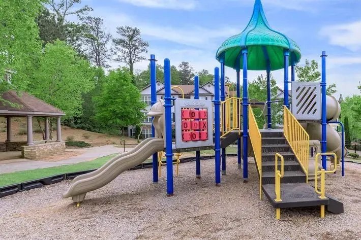 Playground with slides and stairs in a residential community.