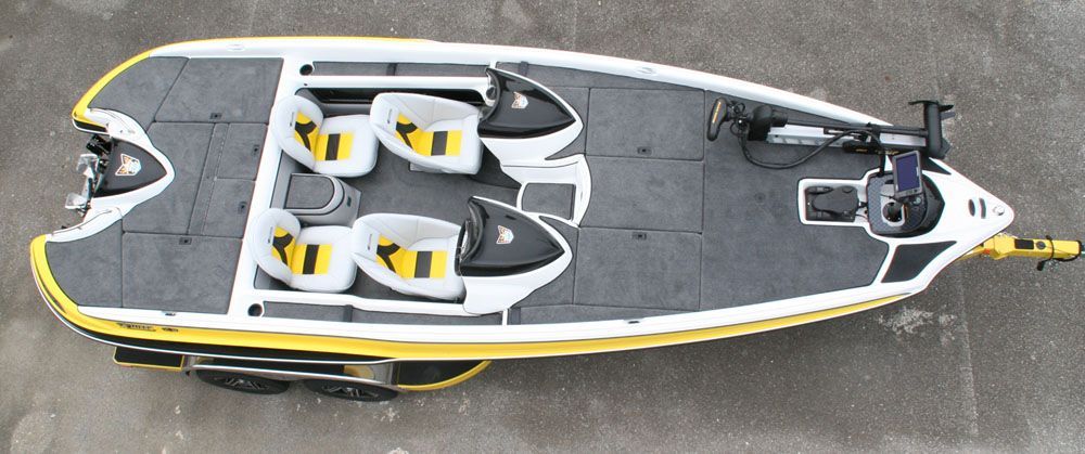 Top-down view of a yellow and white fishing boat with gray flooring and yellow seats.