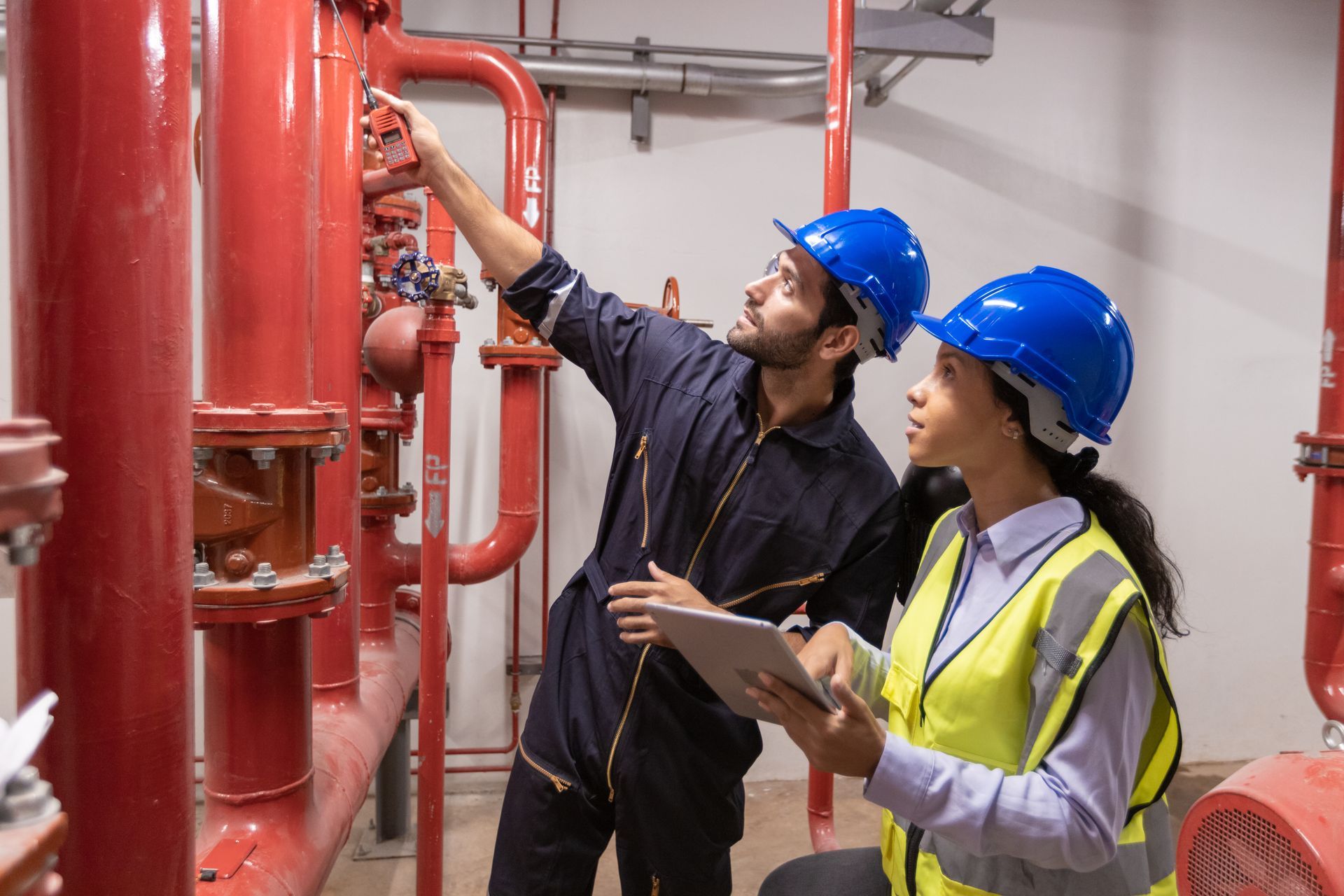 HVAC contractor inspecting commercial piping and valve system