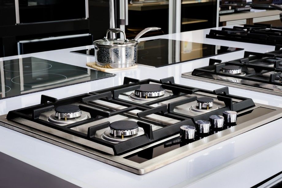 A stove top oven is sitting on top of a counter in a kitchen.