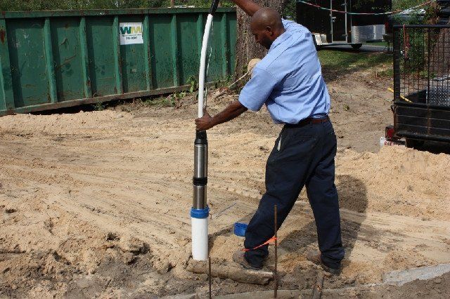 Close-up of a water well with a metal object inside, showcasing essential water well service.