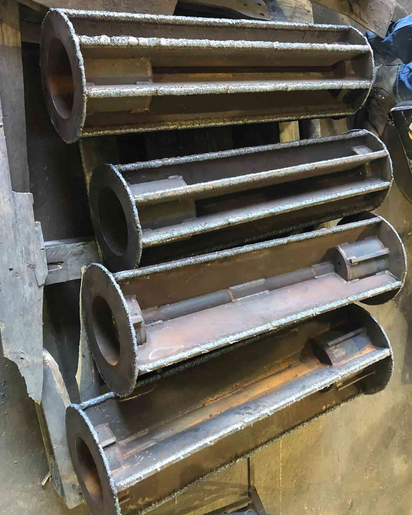 A Bunch of Metal Pipes Are Stacked on Top of Each Other — North Queensland Hard Facing (NQHF) In Hunter Valley, NSW