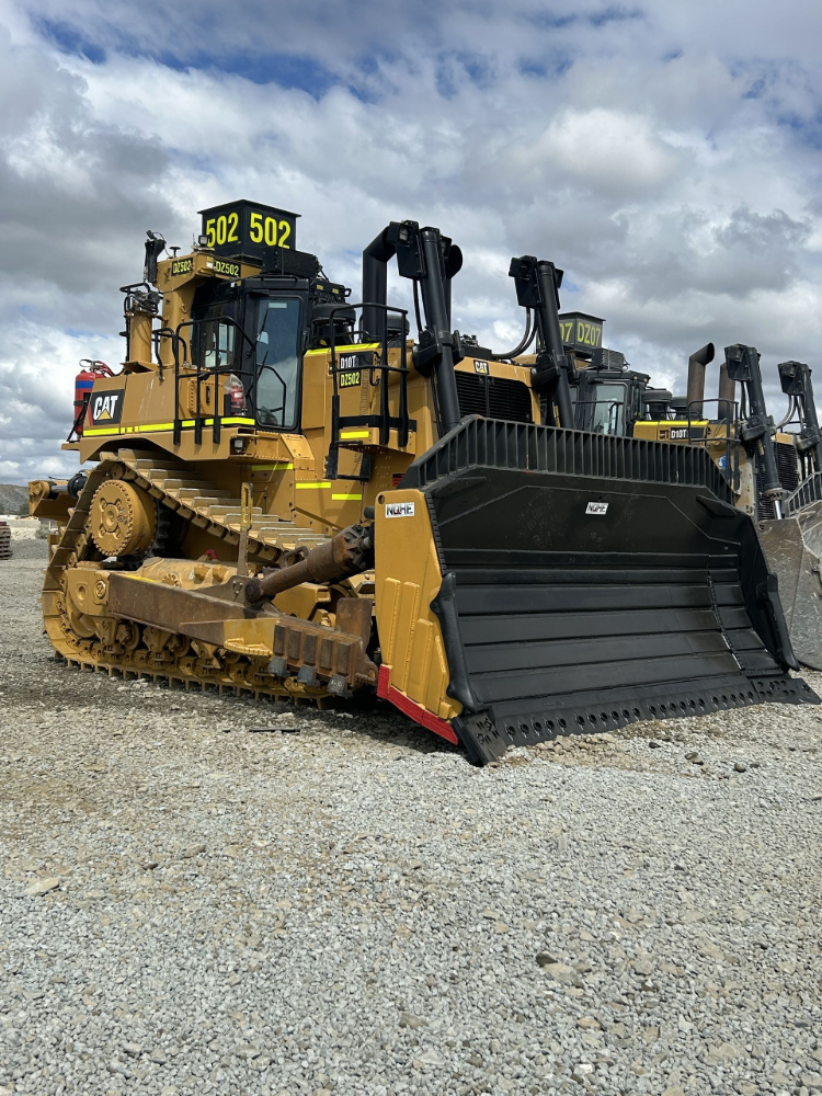 Yellow Caterpillar bulldozer on gravel, outdoors, under a cloudy sky— North Queensland Hard Facing (NQHF) In Fredericksfield, QLD
