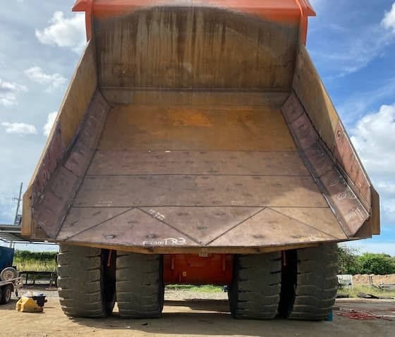 A Large Dump Truck is Parked in a Dirt Field —North Queensland Hard Facing (NQHF) In Fredericksfield, QLD