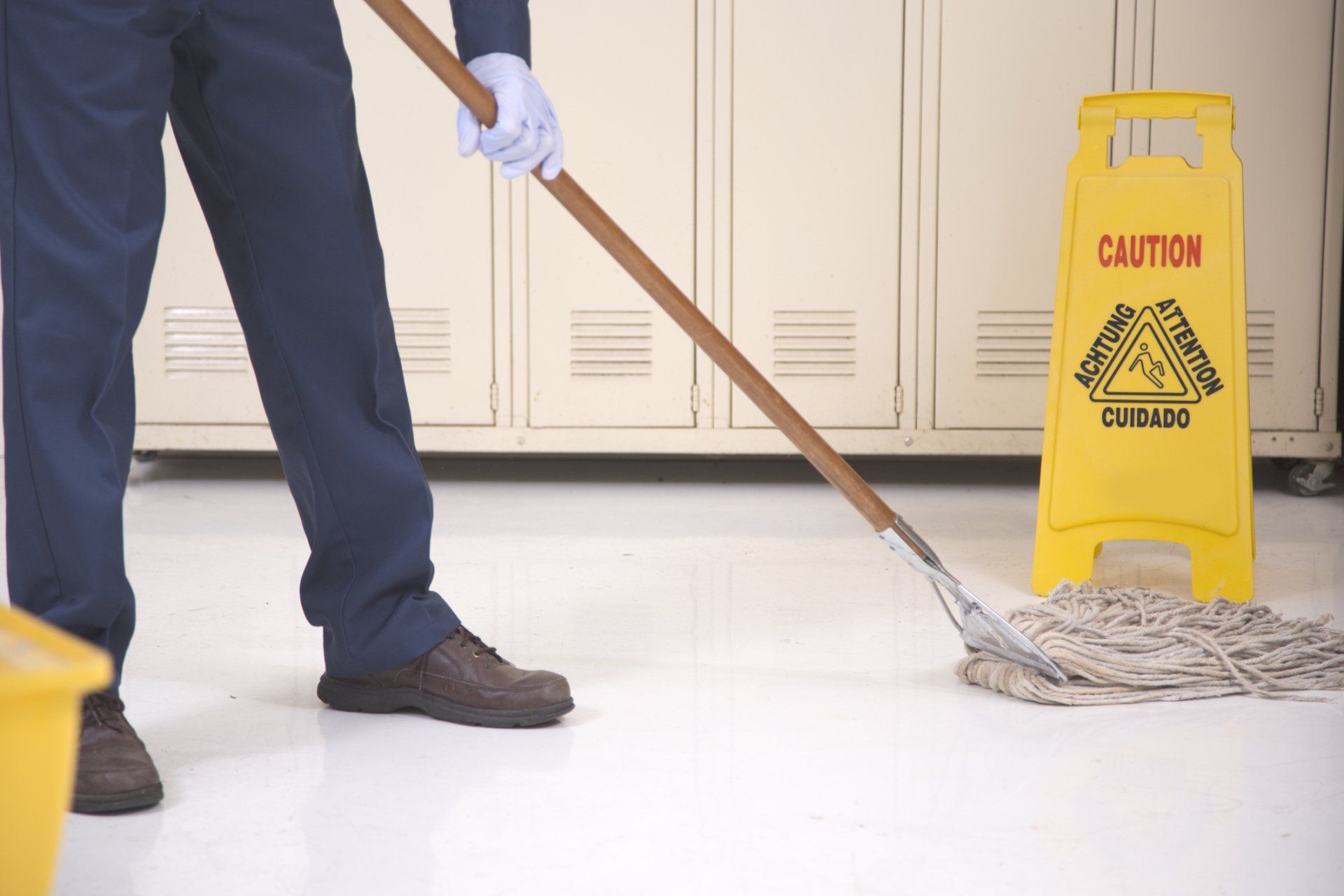 A Janitor Mopping The Floor With Caution Sign - Dover, OH - Rosmary's Cleaning Service A Janitor Mopping The Floor With Caution Sign - Dover, OH - Rosmary's Cleaning Service