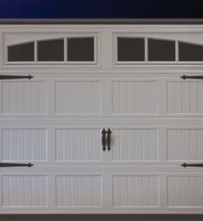 White garage door with windows, vertical panel detailing, and decorative hardware.