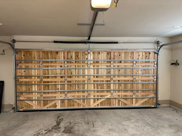 Wooden garage door with metal frame, open in a garage.