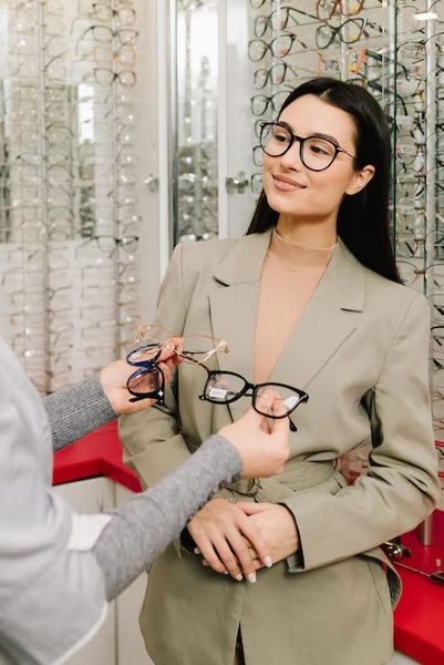 Optometrist using modern diagnostic equipment during eye exam