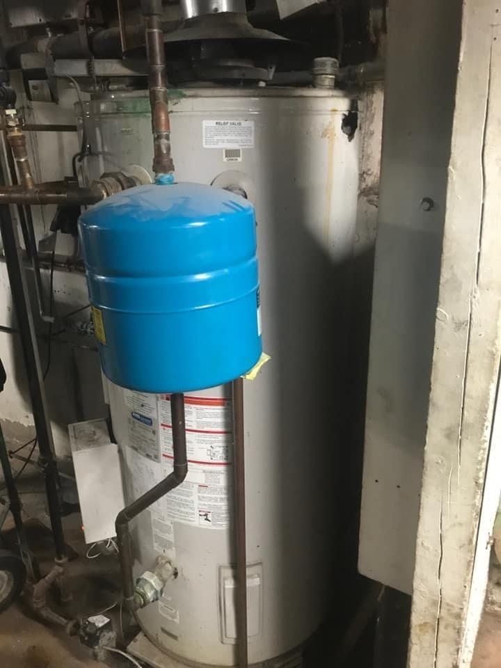 Old A.O. Smith BTR with a hole and expansion tank at a restaurant
