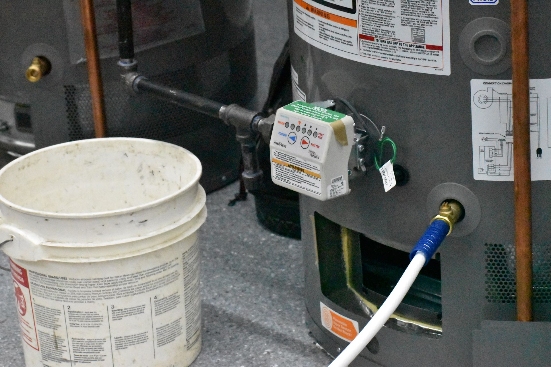 Technician diagnosing issue with natural gas water heater pilot assembly and gas valve