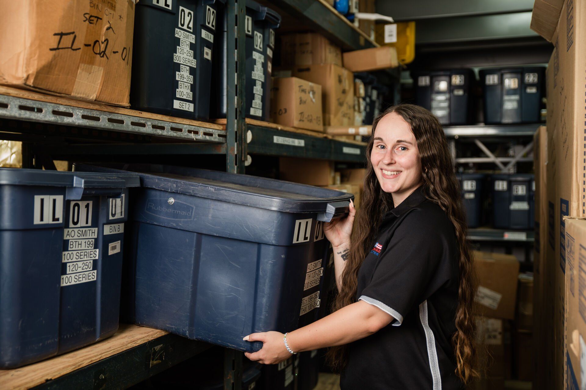 Team member in the warehouse picking a service bin of commercial water heater parts