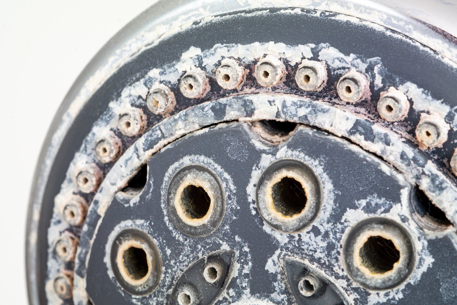 Shower head with white stains from hard water