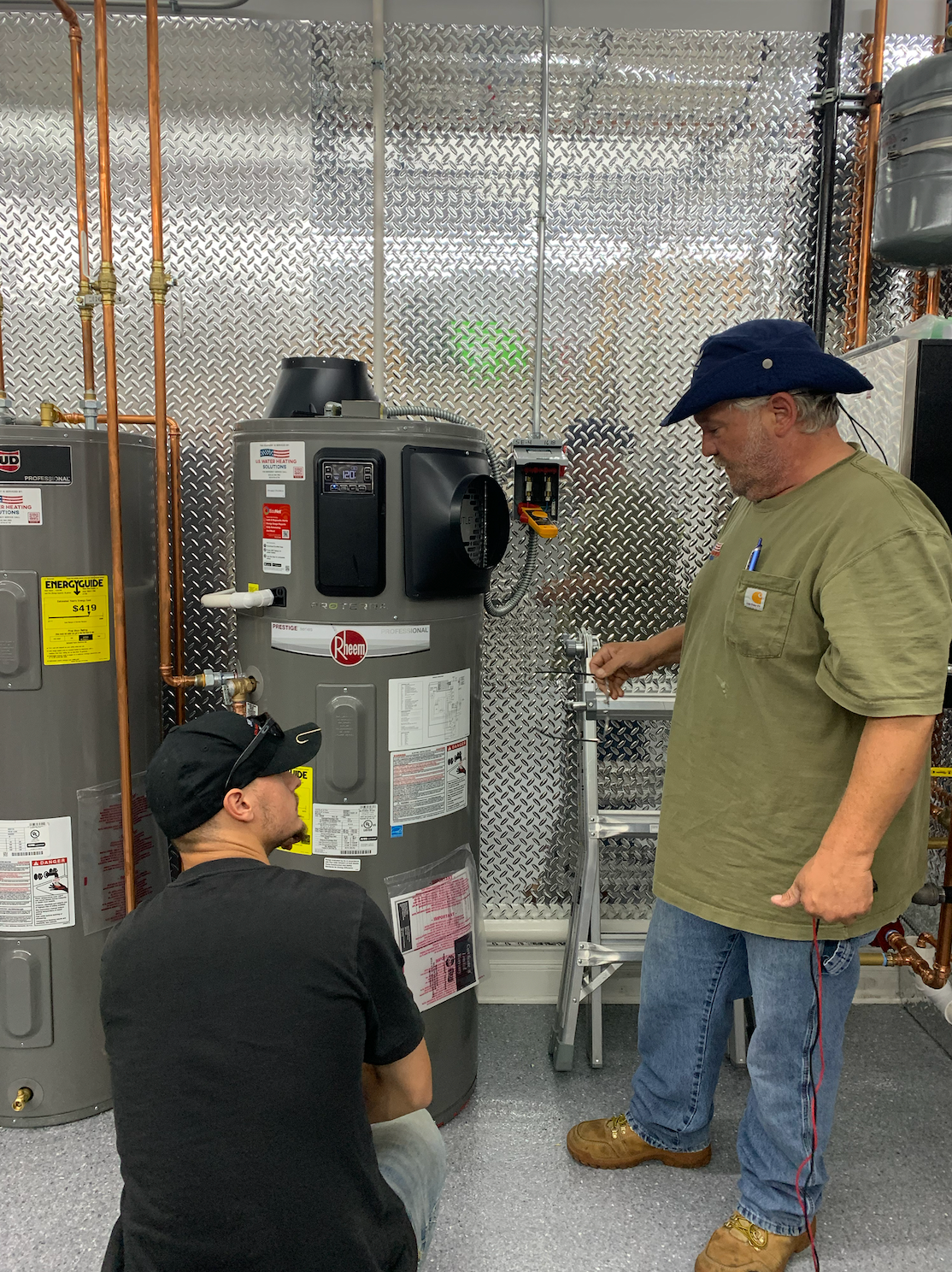 Water heater service technician troubleshooting heat pump water heater