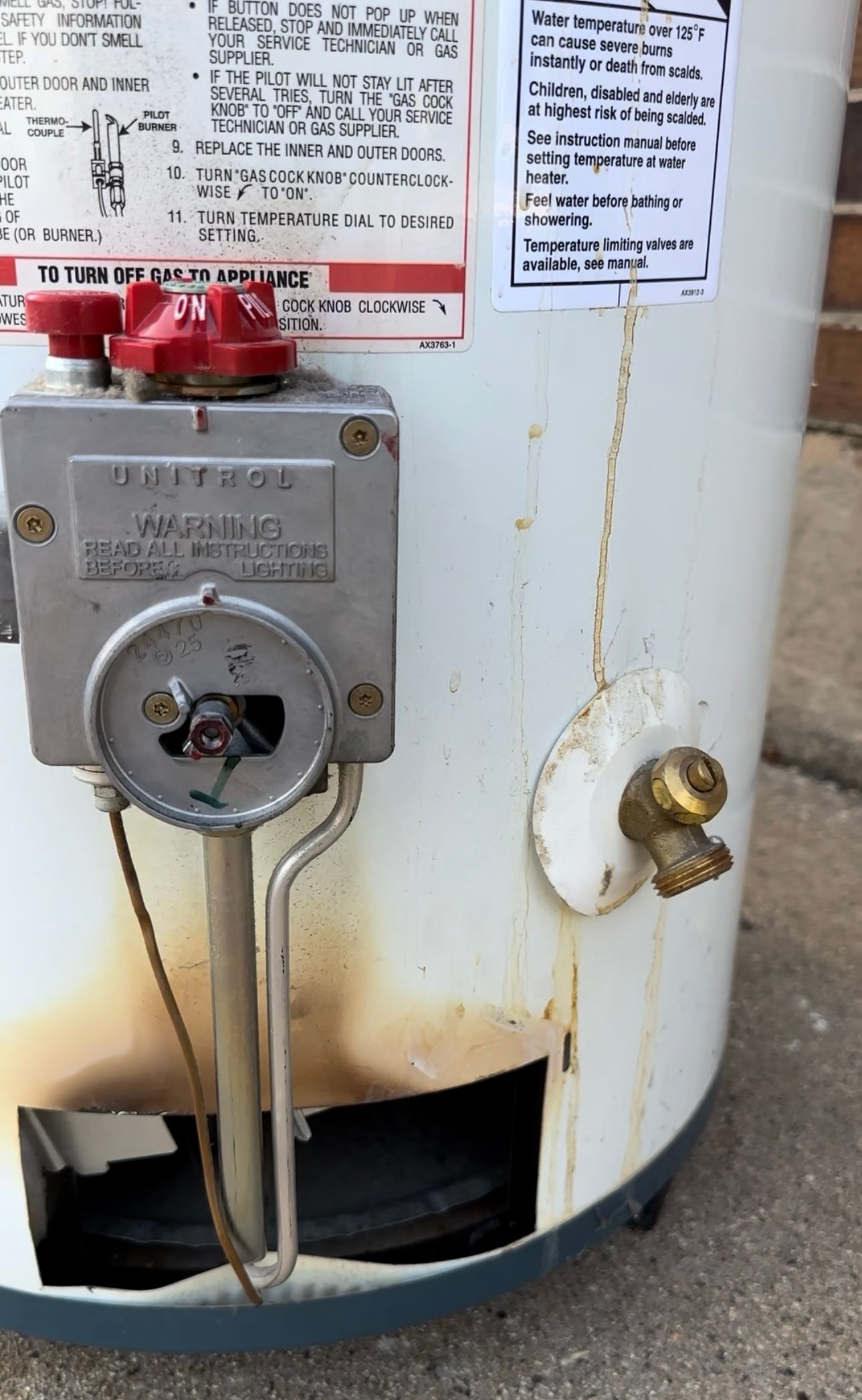 Old water heater with signs of flame rollout, drip marks, and age
