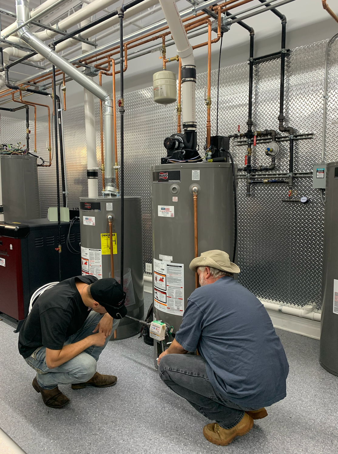 water heater service technicians working on gas water heater