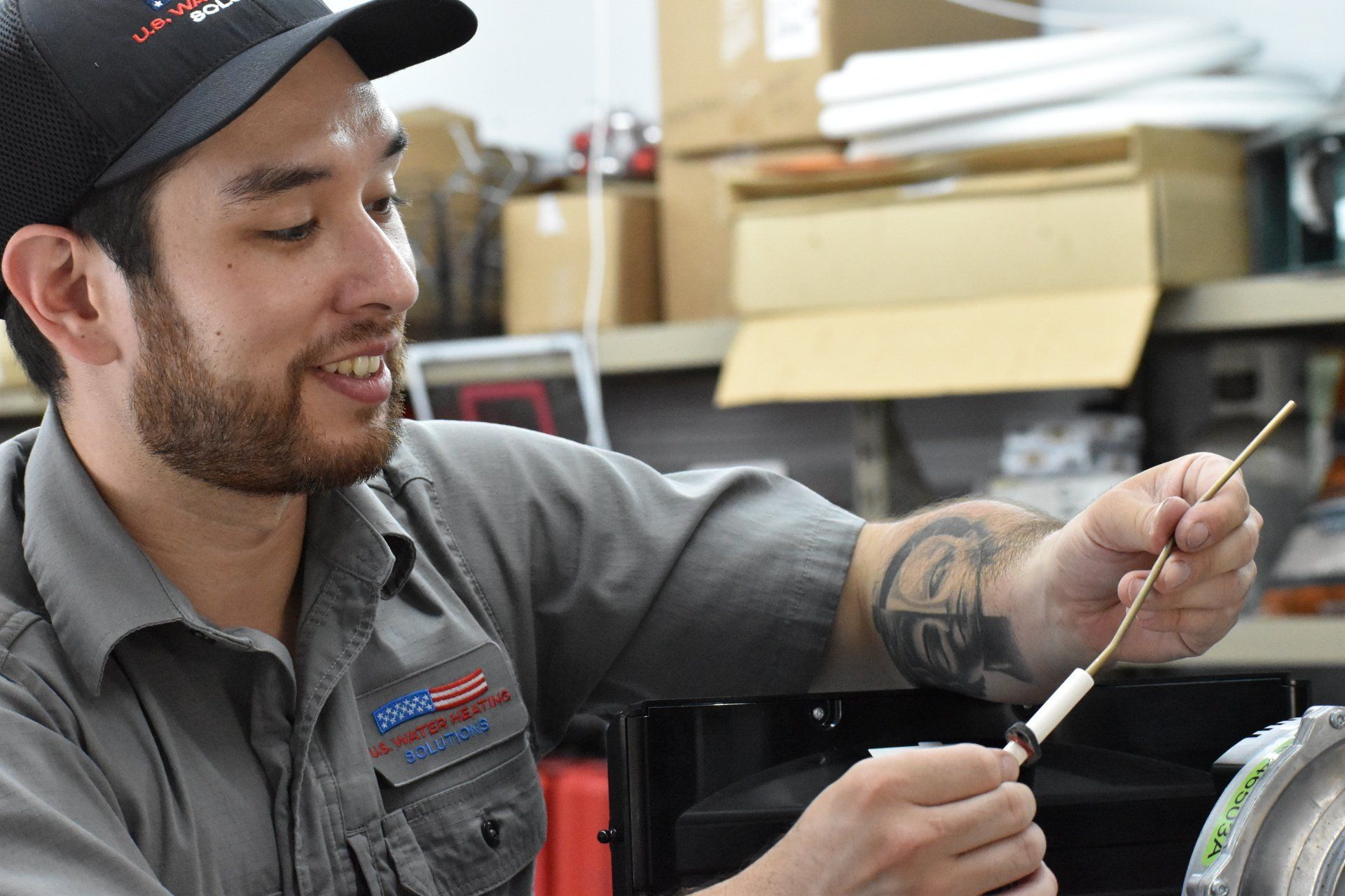 Water Heater Service Technician Examining Commercial Rheem Triton Unit