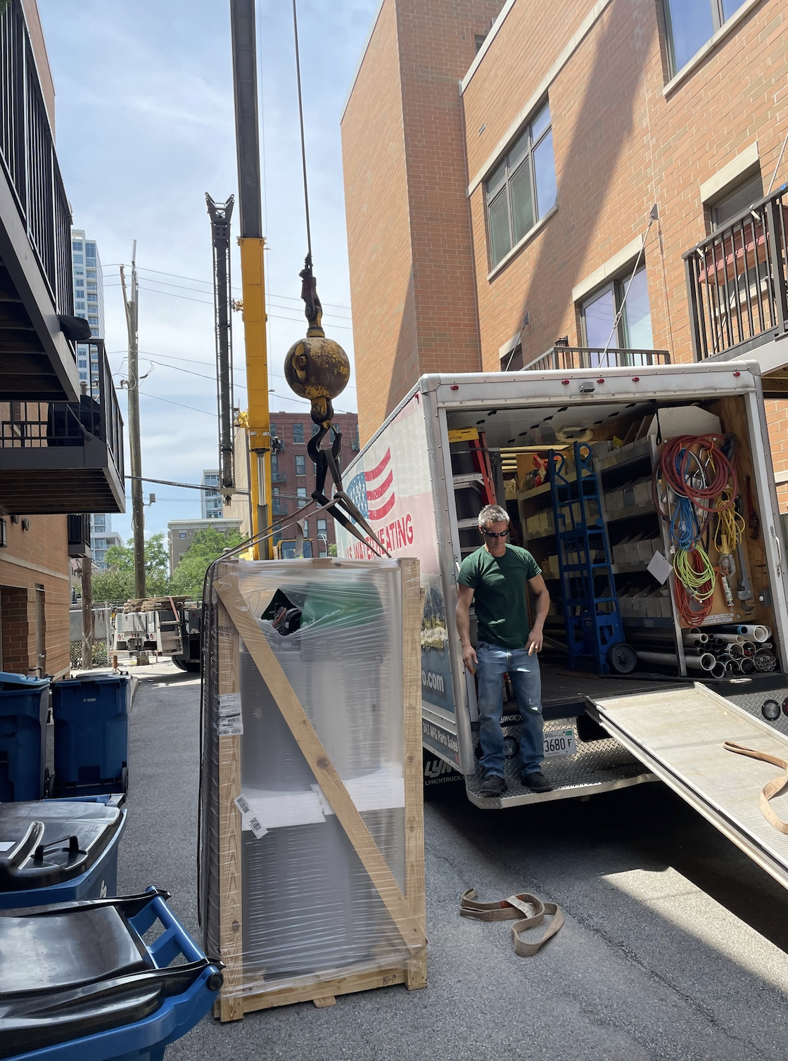 Preparing to lift new water heater by crane