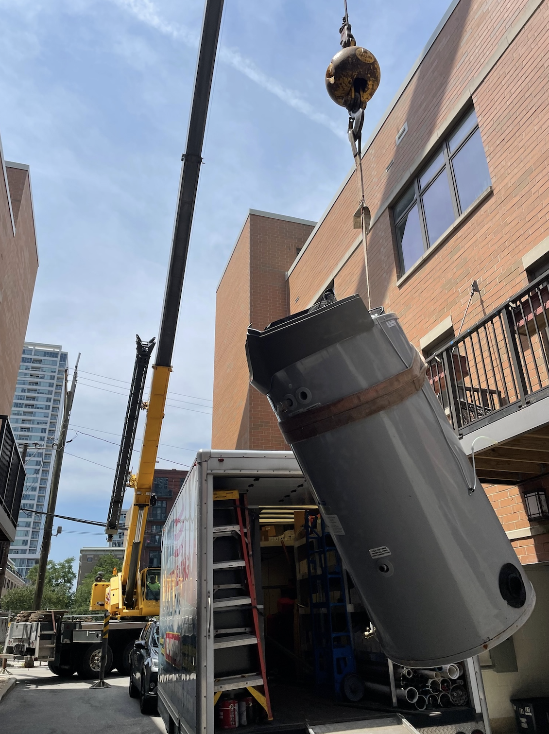 water heater tank on a crane