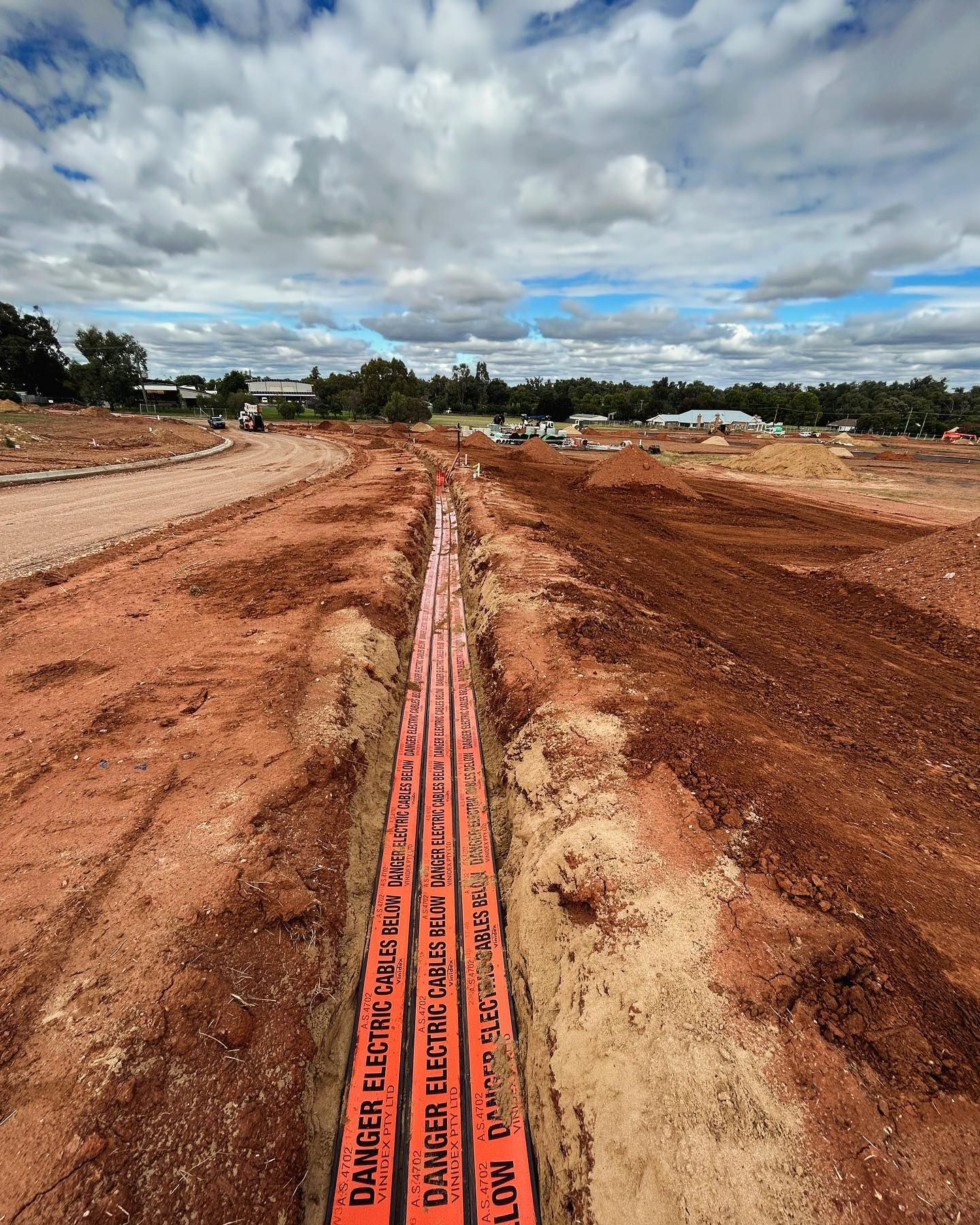 Orange Electrical Conduit Buried in a Trench, Marked With Danger Cable — Central West Power Construction in Orange, NSW