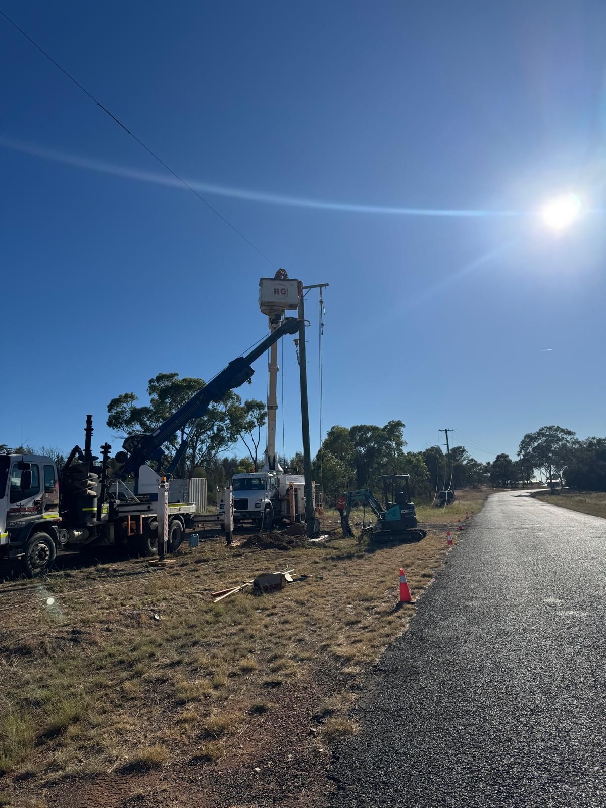 Wooden Utility Pole With Power Lines Against a Blue Sky — Central West Power Construction in Orange, NSW