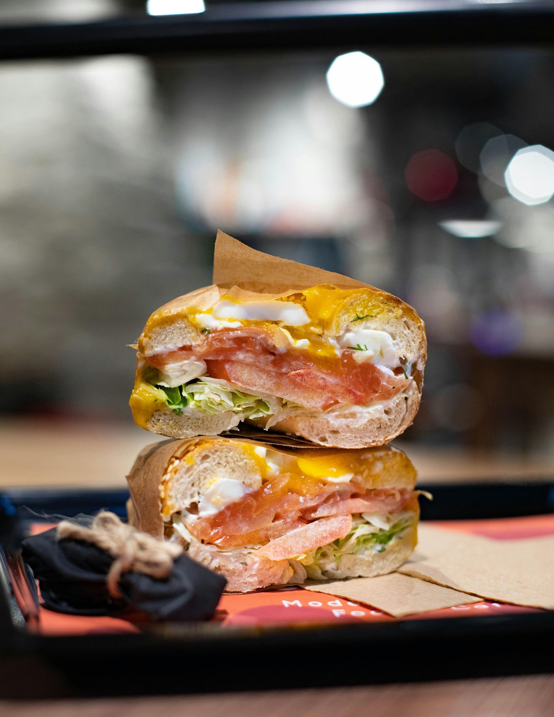 A close up of a sandwich cut in half on a tray.
