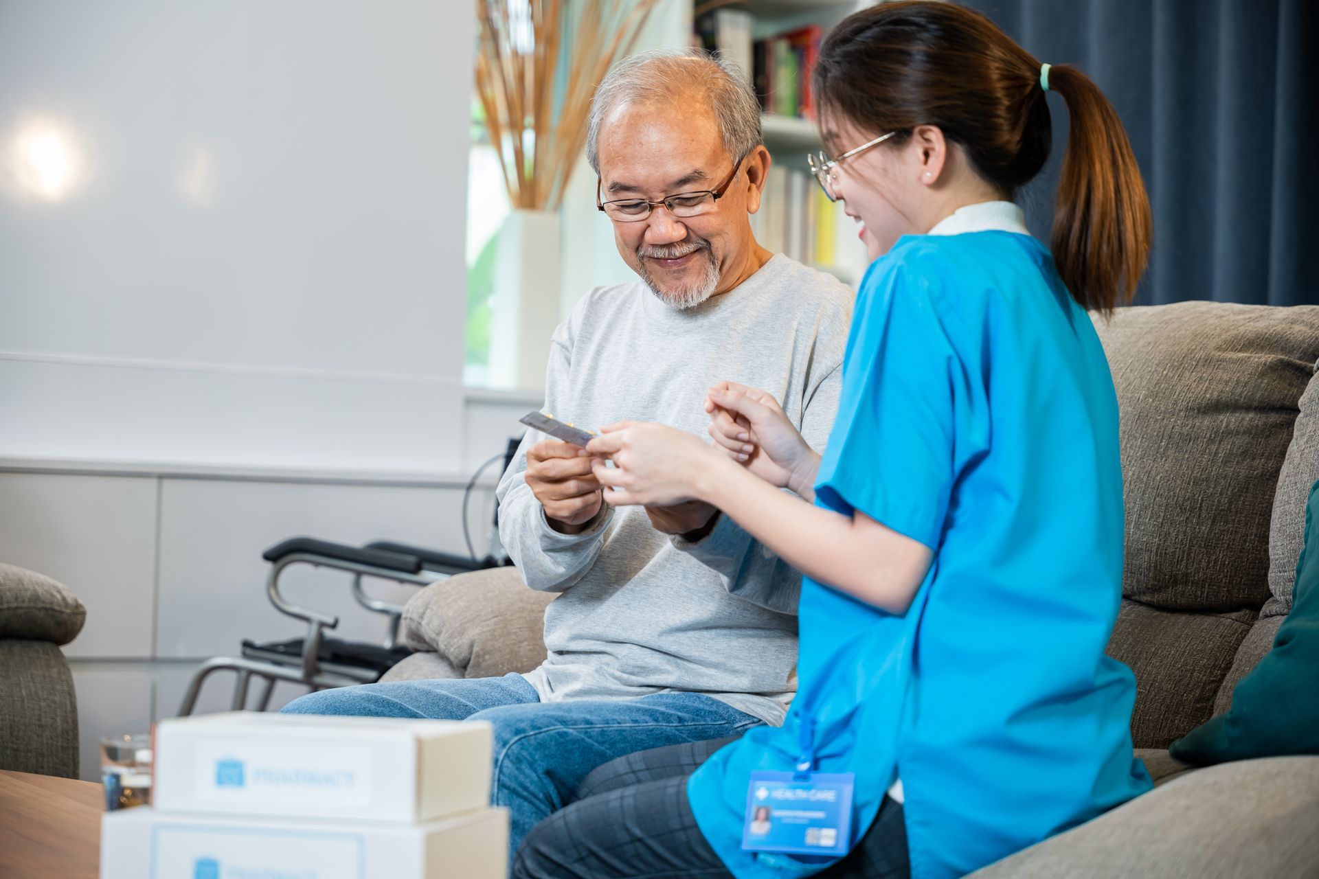 An elderly man and caregiver looking at a card