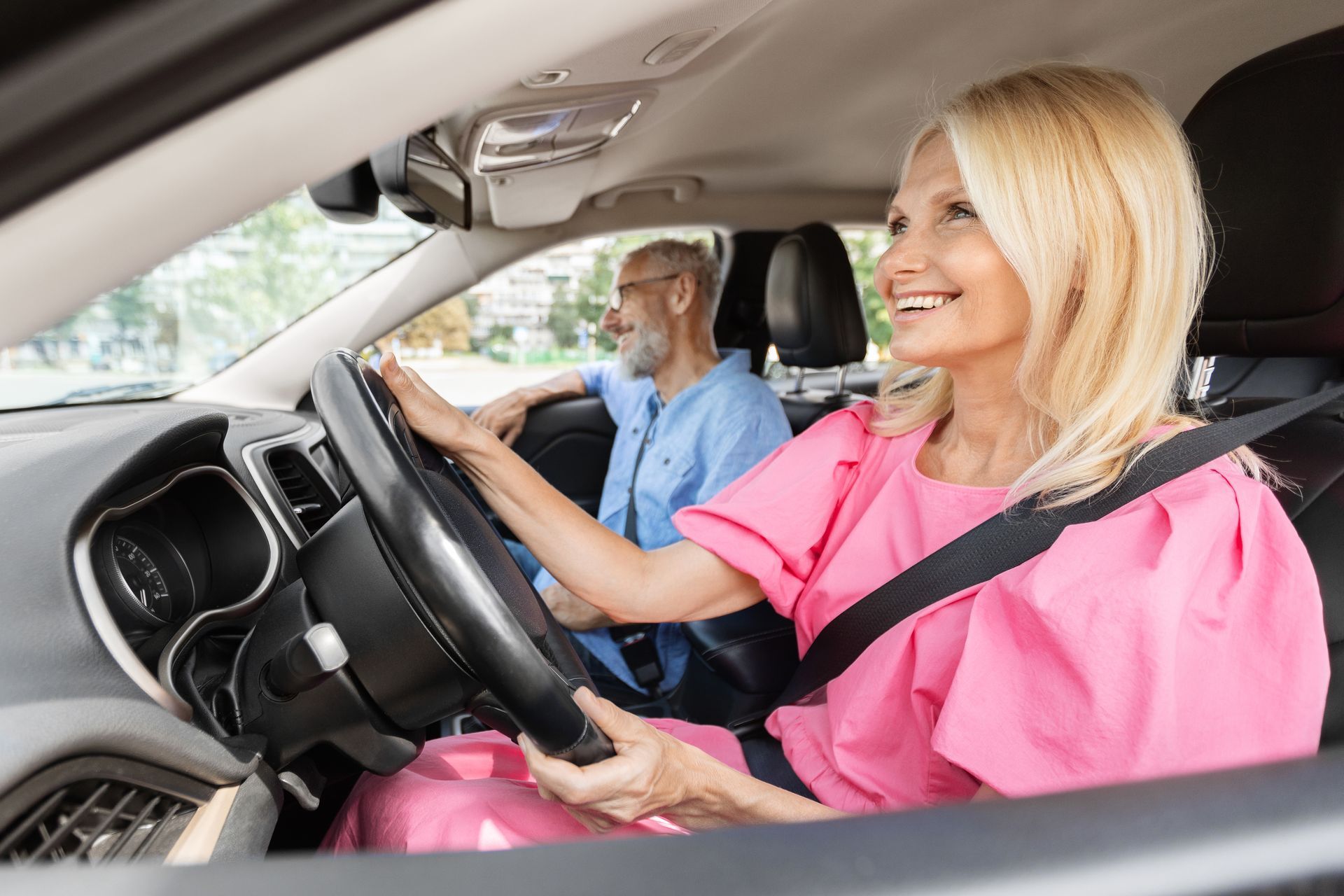 A caregiver driving an elderly man