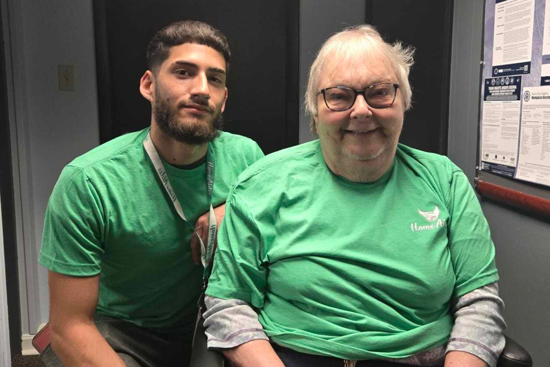 A caregiver sitting next to a client in a wheelchair