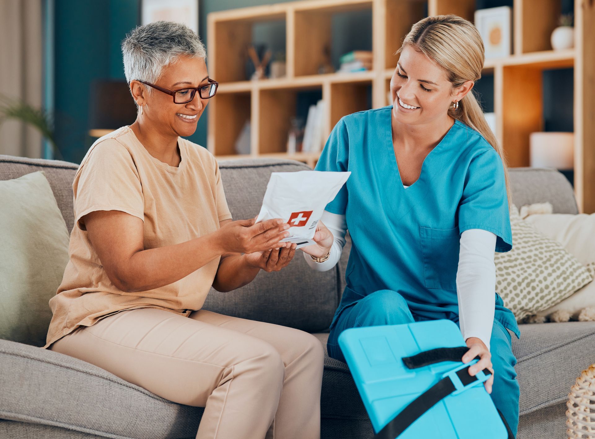 An elderly person and caregiver looking at a prescription