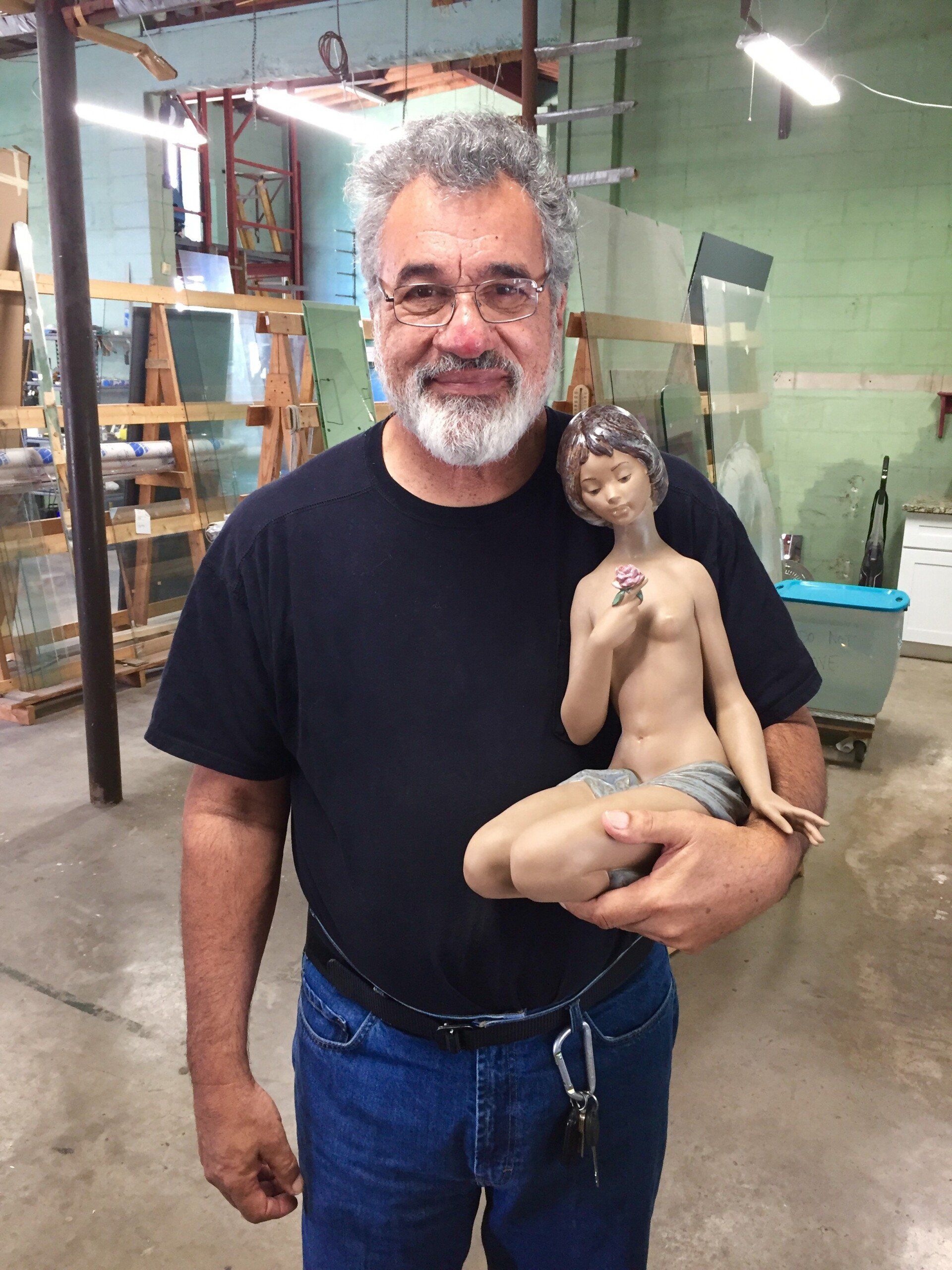 Man Holding A Lladro Porcelain — Tampa, FL — Antique Restoration and Design