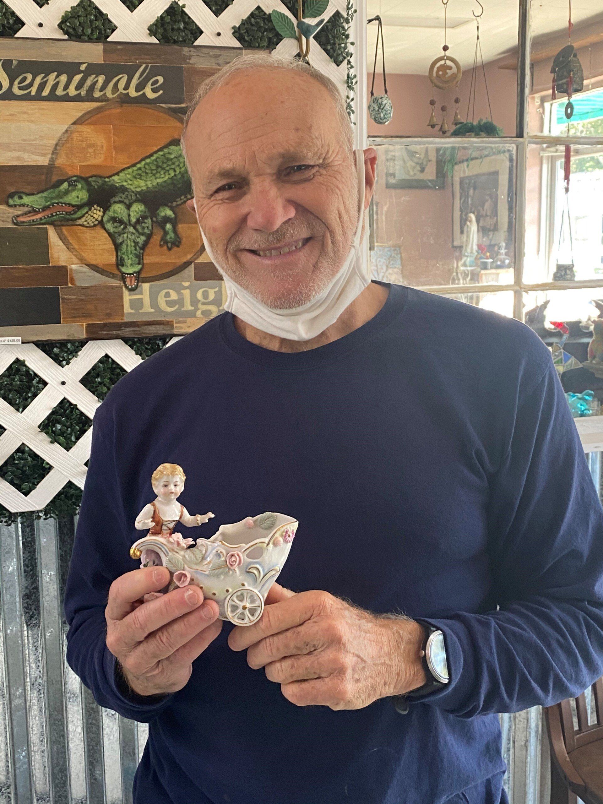 Man Holding Porcelain Figurines — Tampa, FL — Antique Restoration and Design Man Holding Porcelain Figurines — Tampa, FL — Antique Restoration and Design