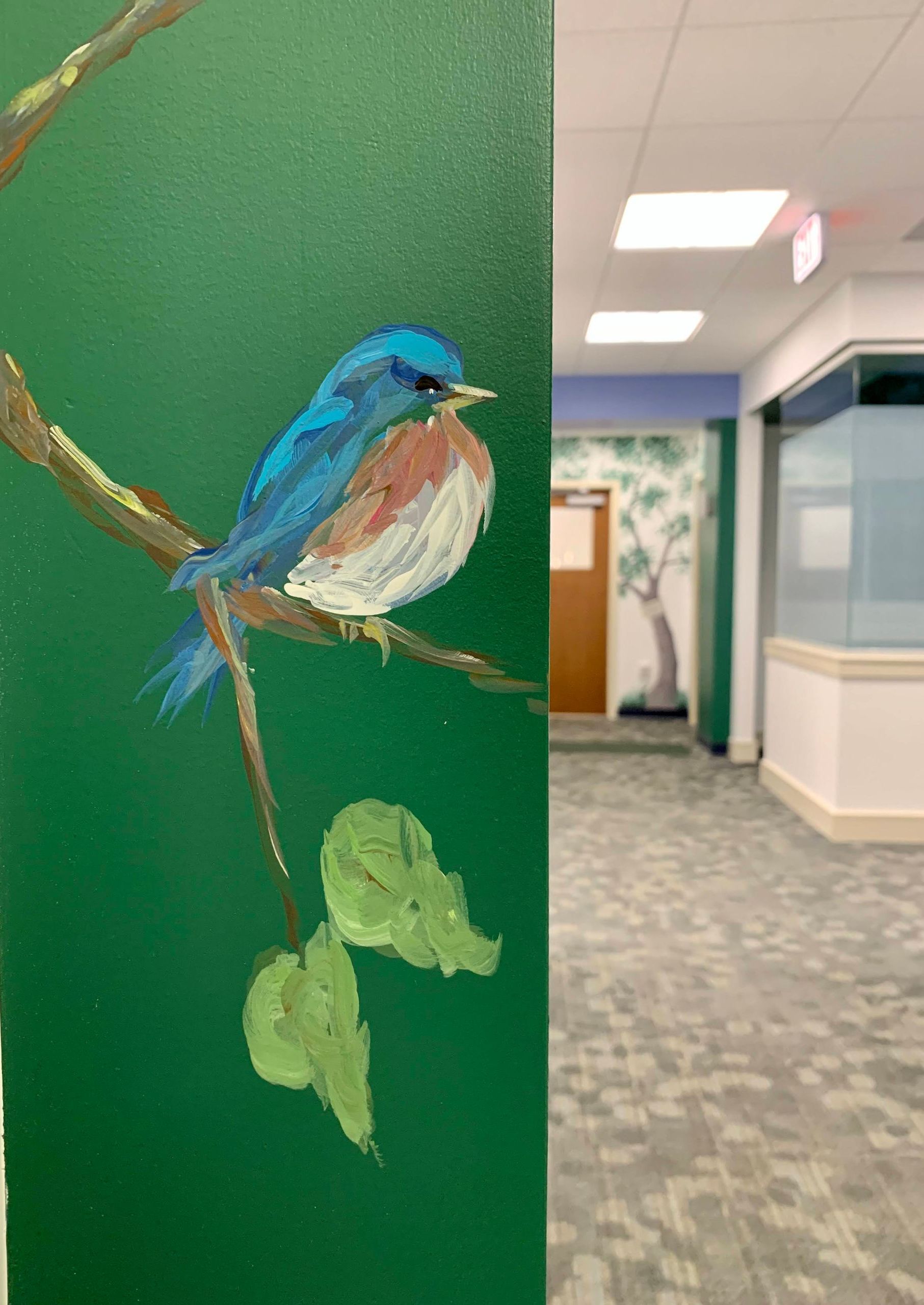Pediatric office mural with blue bird on a branch