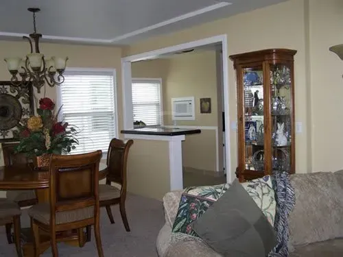 A living room with a dining room table and chairs