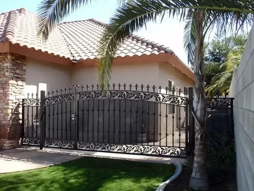 A house with a wrought iron gate in front of it