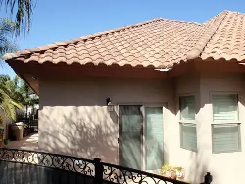A house with a tiled roof and a sliding glass door.