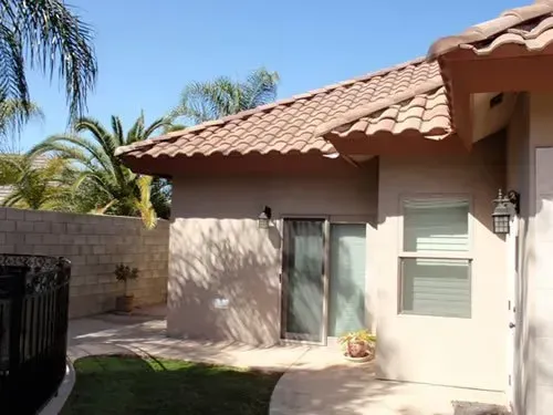 A house with a tiled roof and a sliding glass door