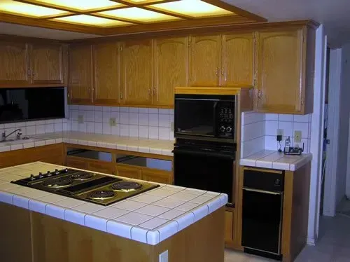 A kitchen with wooden cabinets and a stove top oven