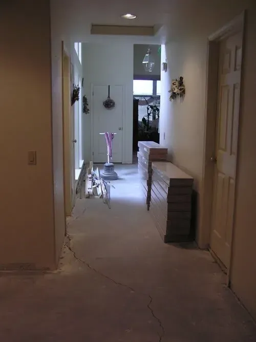 A hallway with a stack of boxes on the floor
