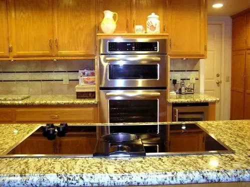 A kitchen with stainless steel appliances and granite counter tops