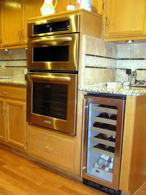 A kitchen with stainless steel appliances and a wine cooler