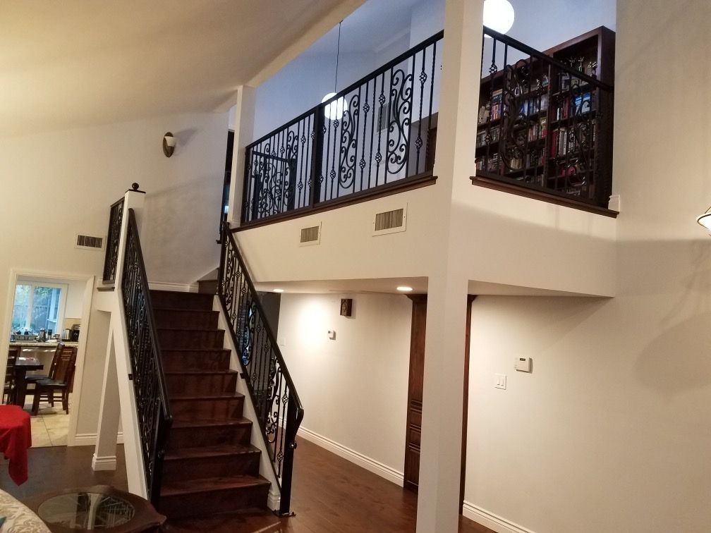A living room with stairs leading up to the second floor