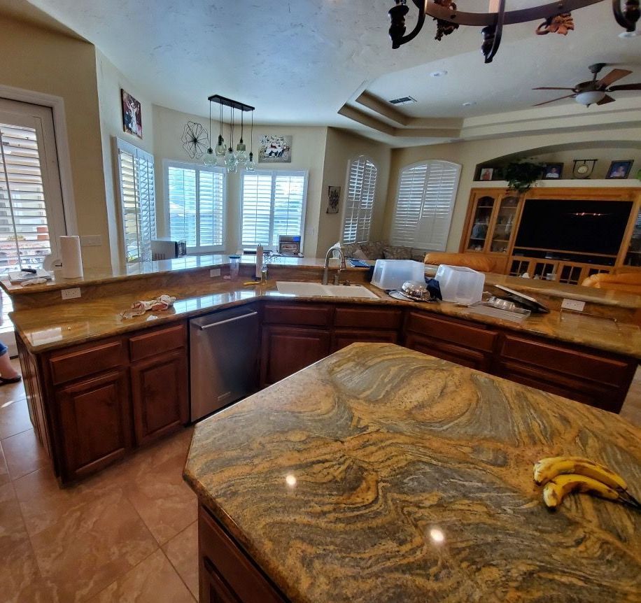 A kitchen with granite counter tops and wooden cabinets