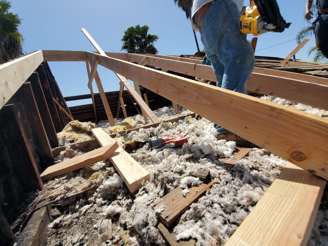 A man is working on the roof of a building