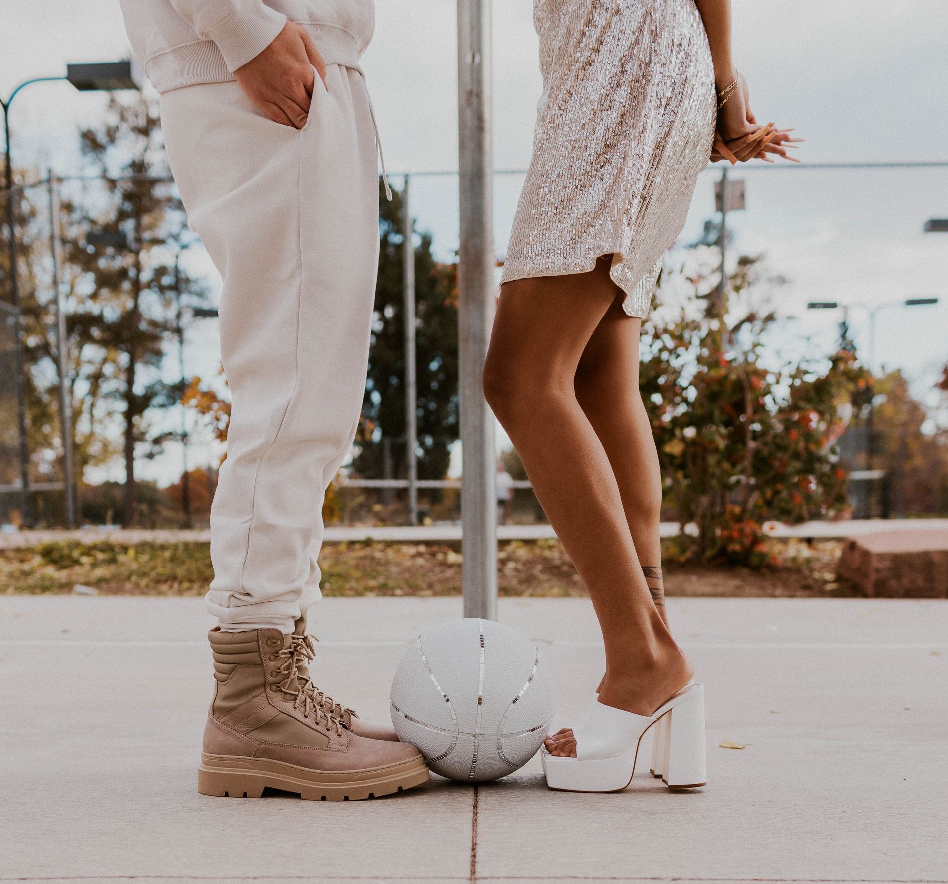 Scotty modeling for a styled shoot with a female model for a wedding photoshoot themed around basketball