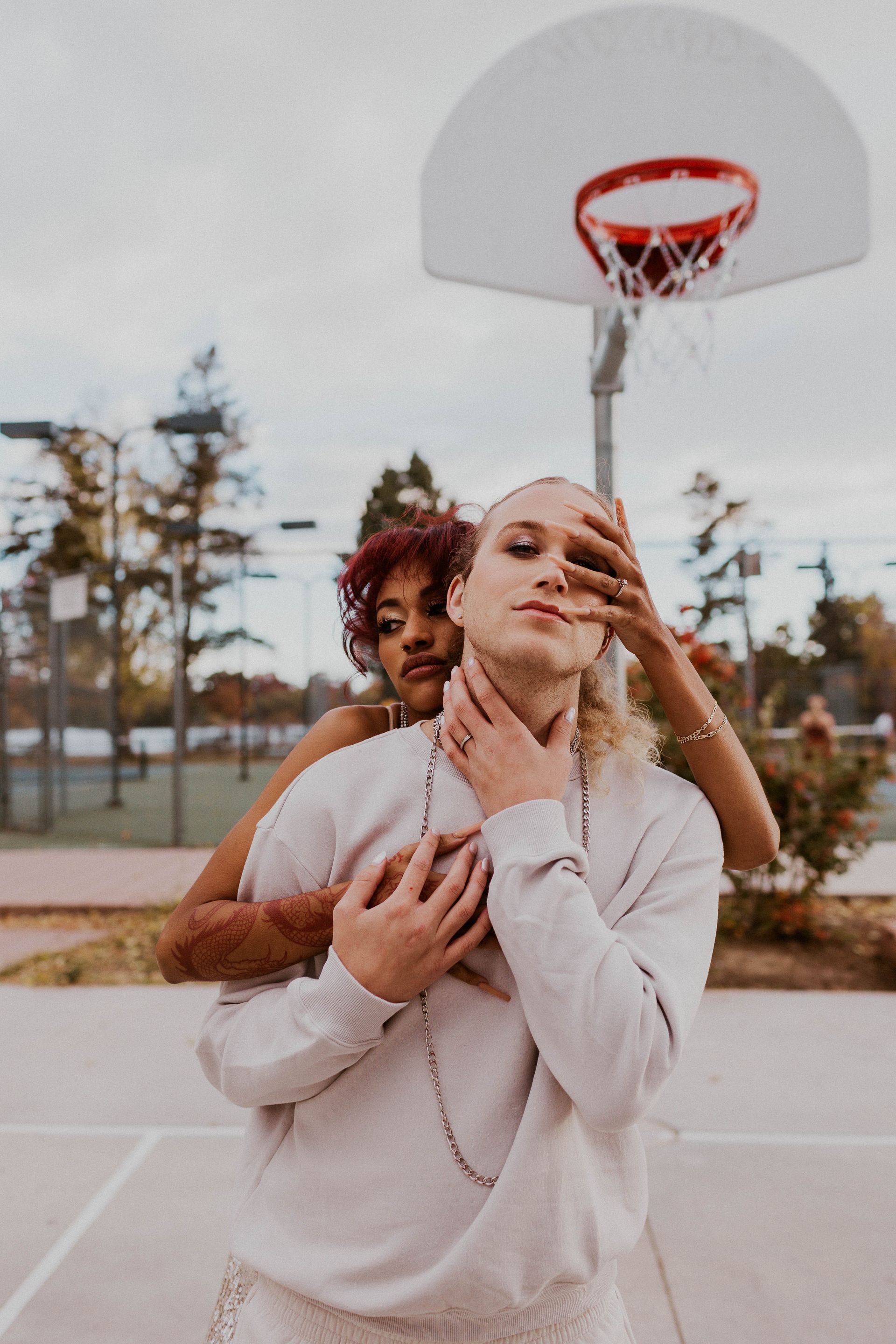 Scotty modeling for a styled shoot with a female model for a wedding photoshoot themed around basketball