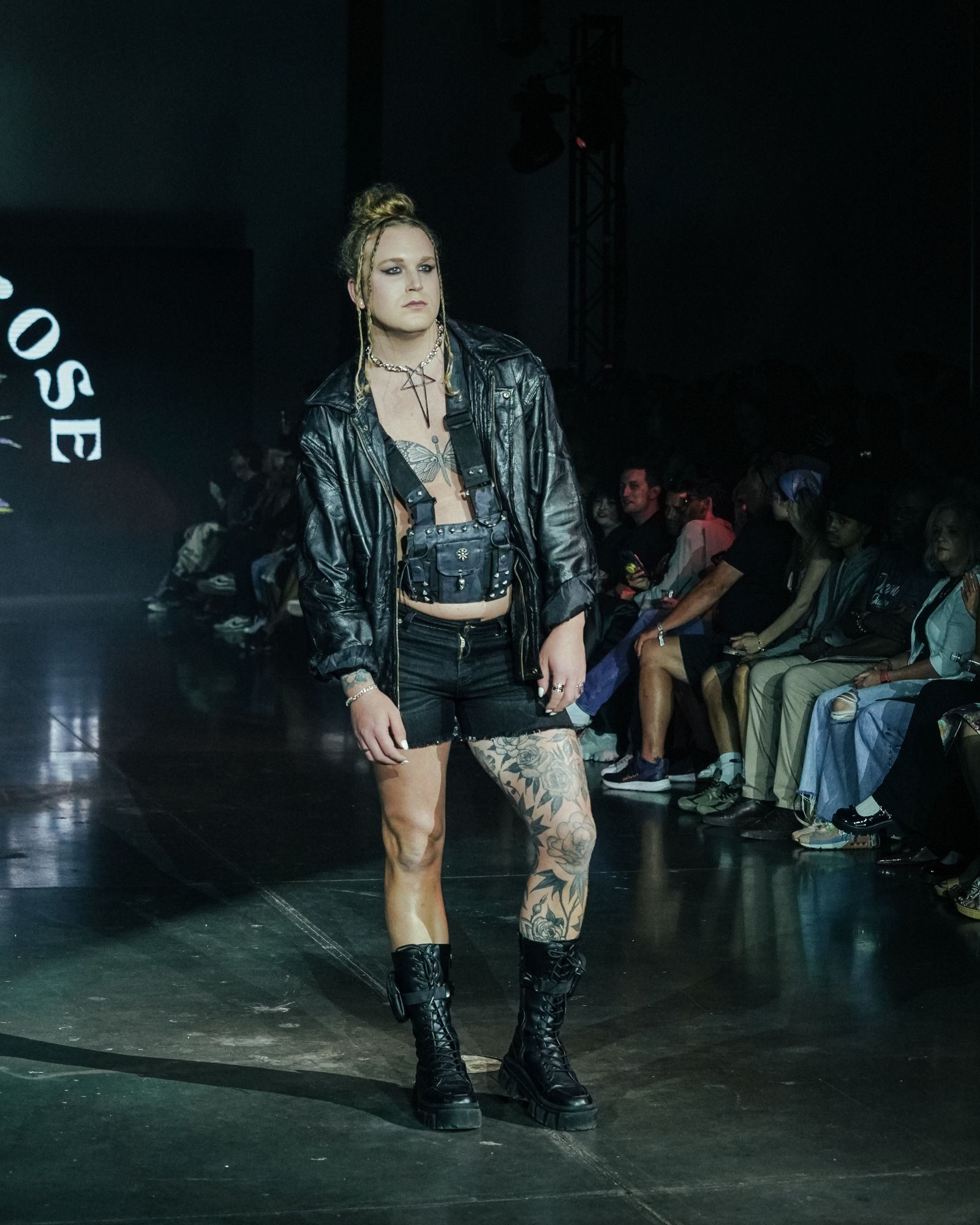 Scotty Strehlow is walking down a runway at a fashion show for Denver Fashion Week.