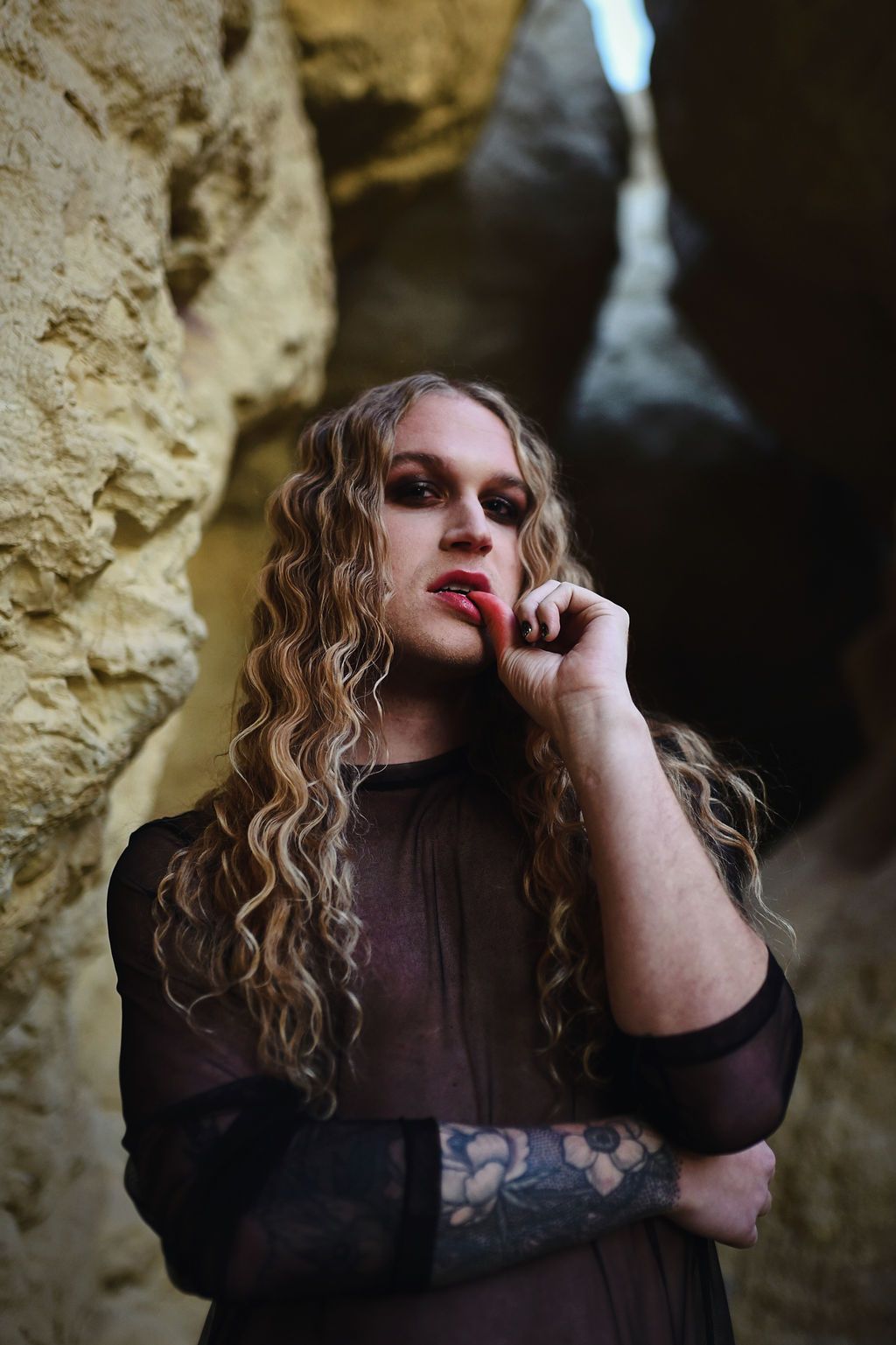 Scotty doing a model pose for a Halloween photoshoot in a cave